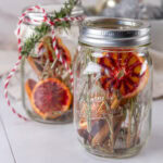 square crop of two mason jars filled with aromatic things.