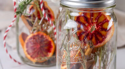 square crop of two mason jars filled with aromatic things.