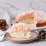 square crop of a slice of cake in front of the whole cake.