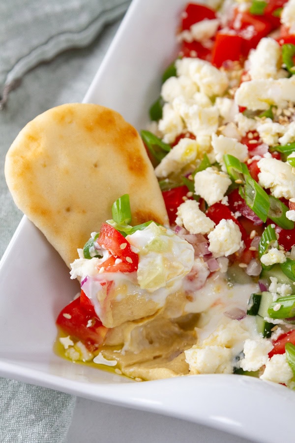a naan in some hummus dip. 