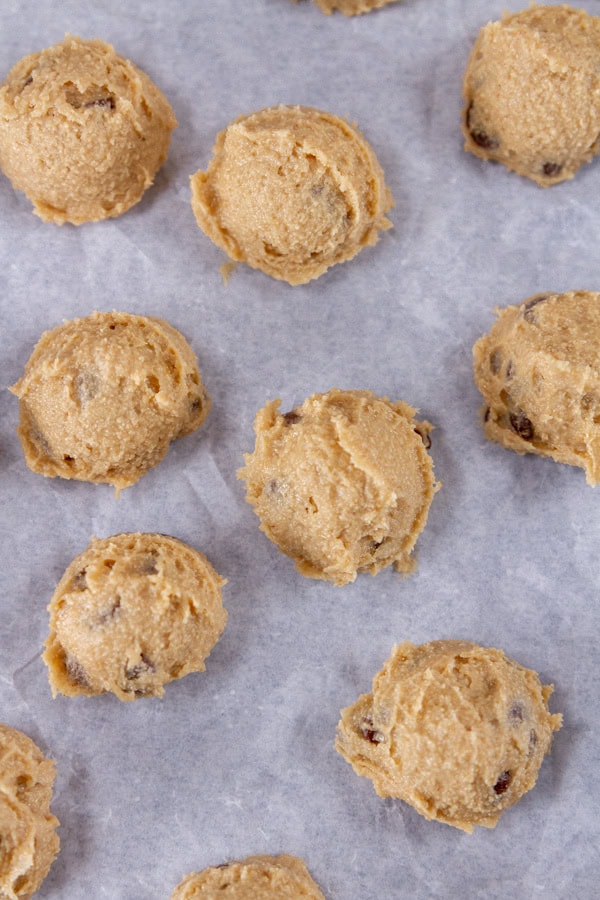 cookie dough balls on parchment paper.