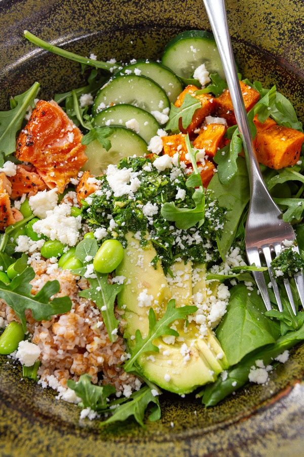 close up on a salad bowl with a fork on the right.