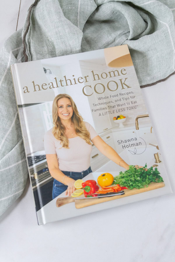 a cookbook on a green cloth.