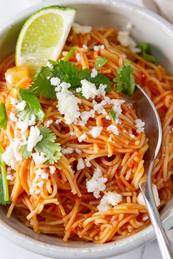 a serving of Mexican Sopa de Fideo with a spoon in it.