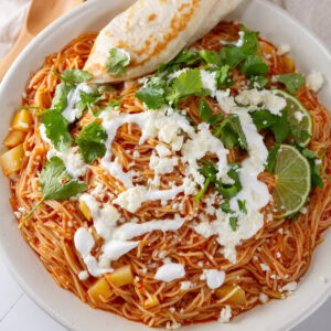 square crop of a bowl of noodle soup with lots of toppings.