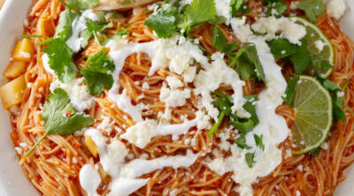 square crop of a bowl of noodle soup with lots of toppings.