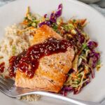 square crop of teriyaki salmon on rice and cabbage slaw.