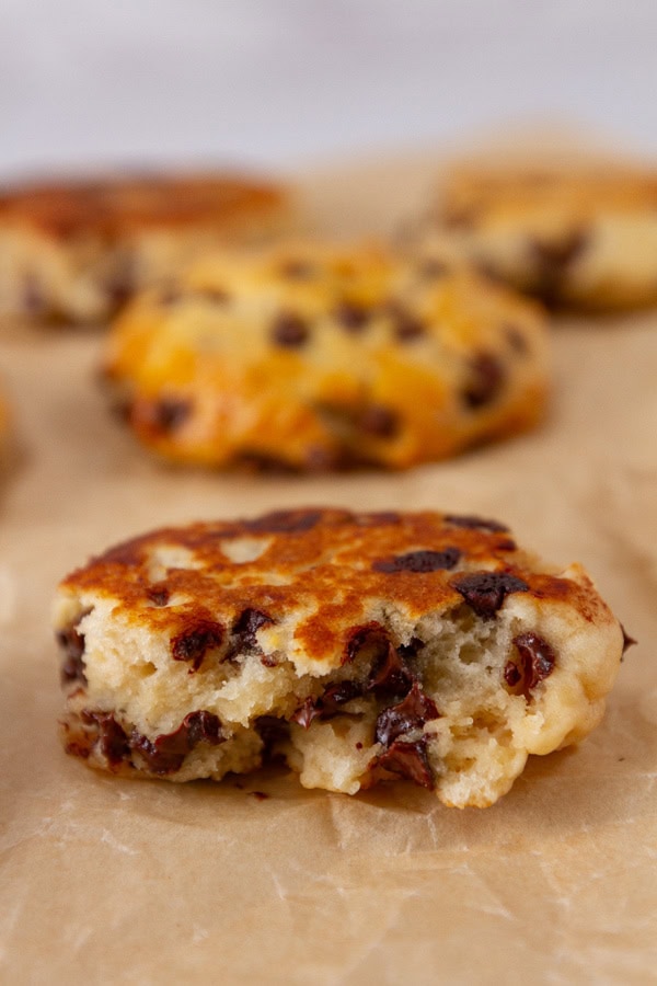 a chocolate chip biscuit that's been broken open so you can see the inside texture.