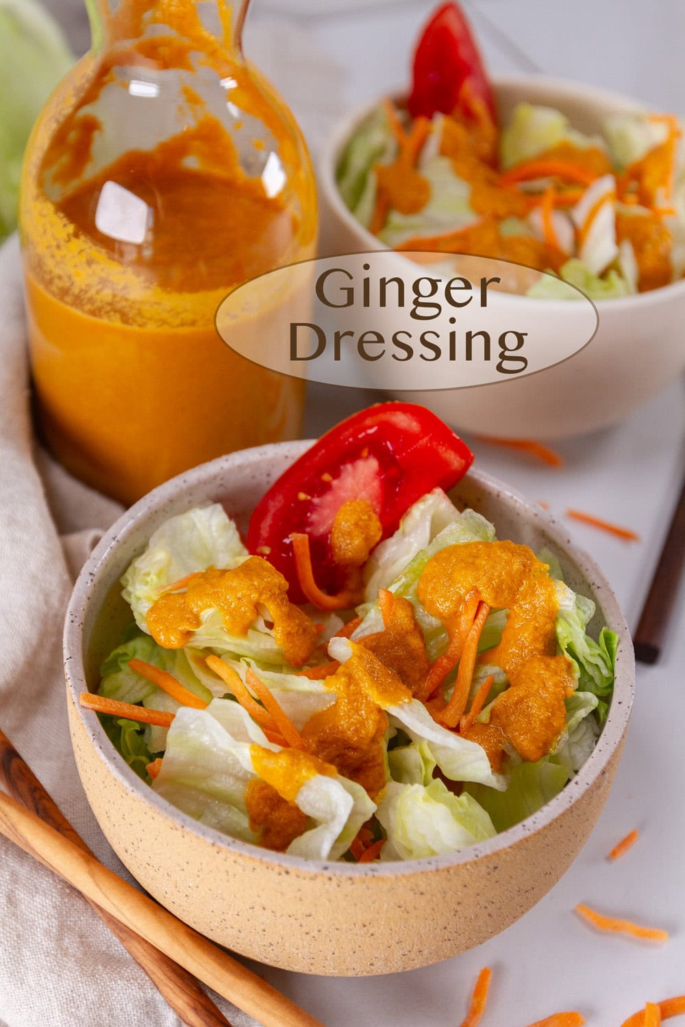Ginger dressing in a bottle and poured out onto an iceberg salad.