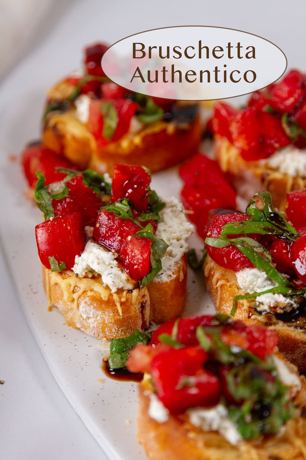 bruschetta appetizers on a white serving tray.
