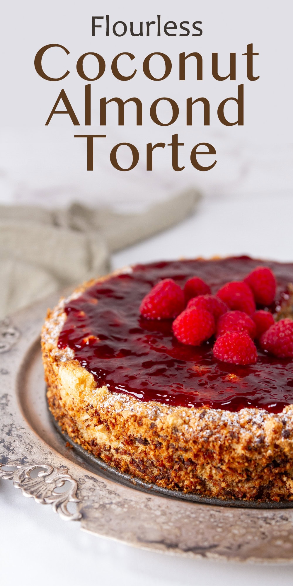a cake topped with raspberry jam on a silver platter.
