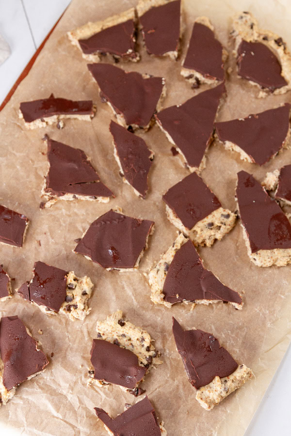 bark broken into smaller pieces on a brown parchment paper.