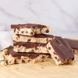 square crop of pieces of cookie dough bark stacked up.