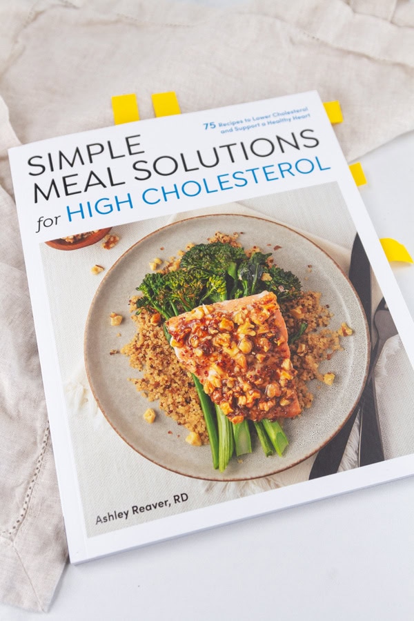 a cookbook with post it notes sticking out the sides.