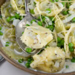 square crop of a bowl of cooked tortellini.