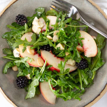 square crop of looking down into a bowl of salad with summer ingredients.