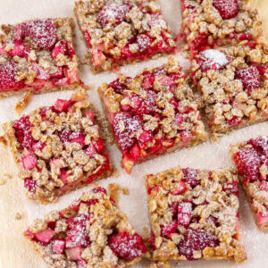 square crop of a batch of dessert bars on a piece of parchment paper.