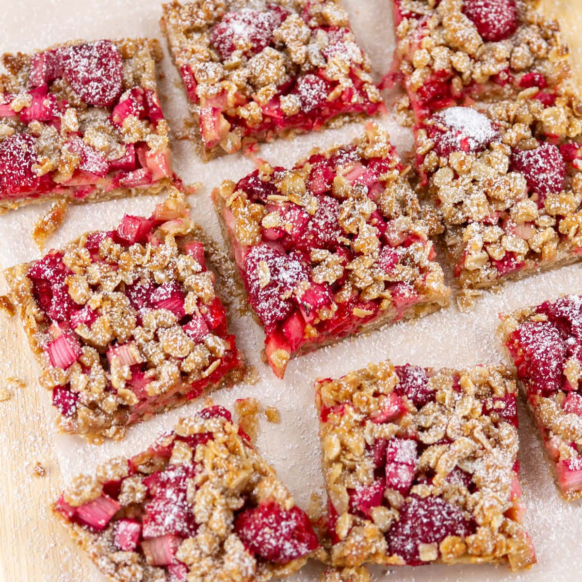square crop of a batch of dessert bars on a piece of parchment paper.