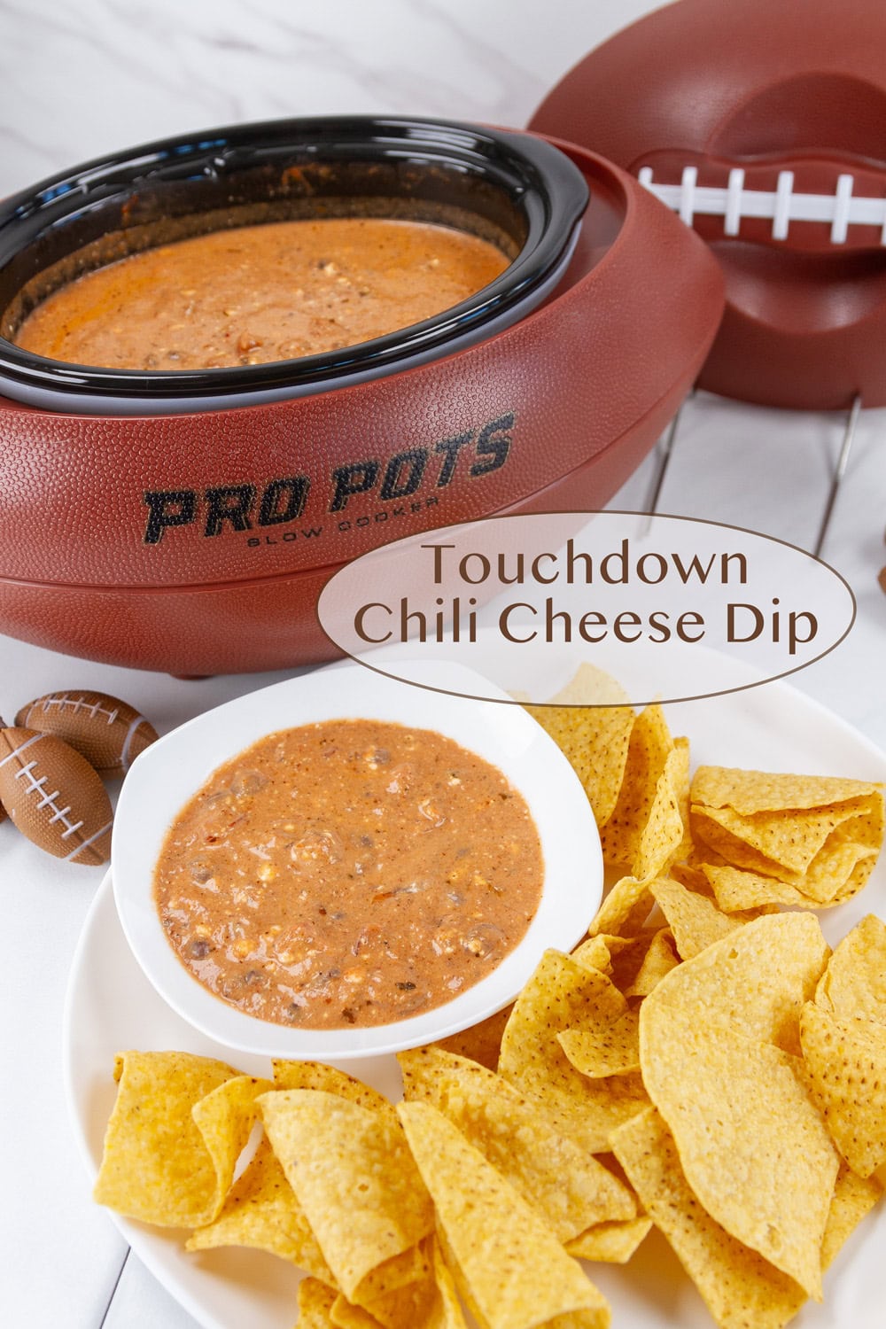 a football shaped slow cooker with dip in it and a serving of dip with chips in front of it.