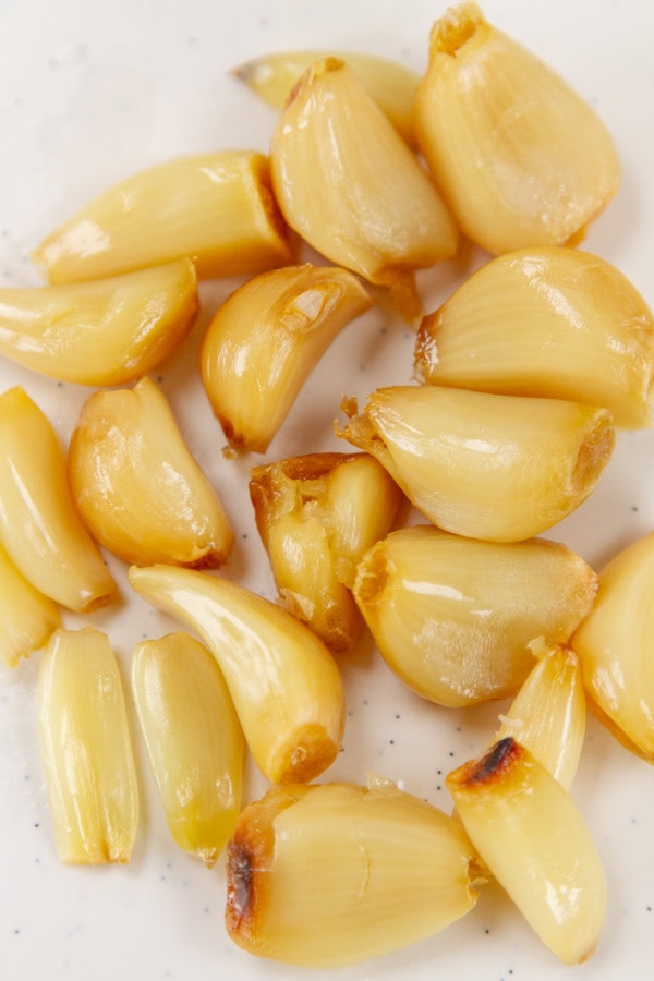 peeled roasted garlic on a piece of parchment paper.