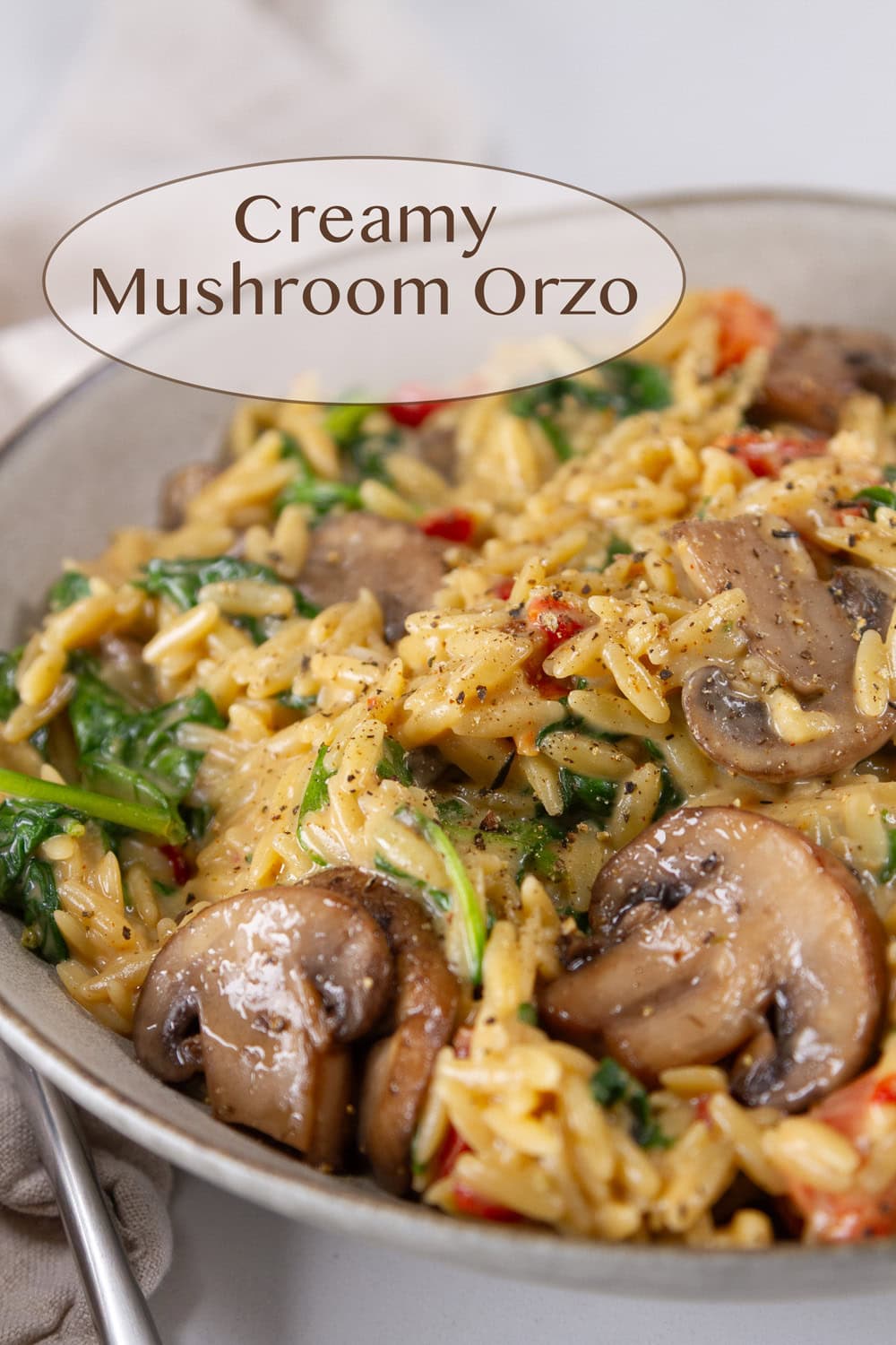 a bowl of orzo with veggies in a creamy sauce.