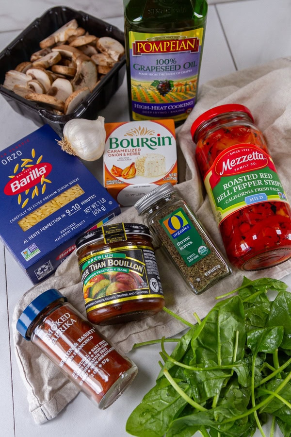 Saut&eacute;ed mushroom ingredients including garlic, roasted red peppers, fresh spinach, caramelized onion, thyme, and high-quality olive oil for healthy cooking.