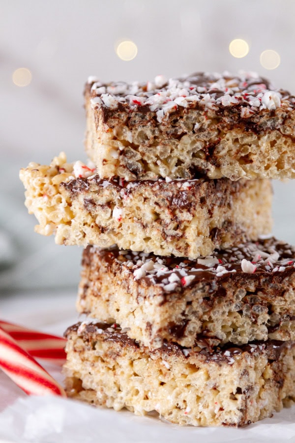a stack of rice krispies treats with some candy canes. 