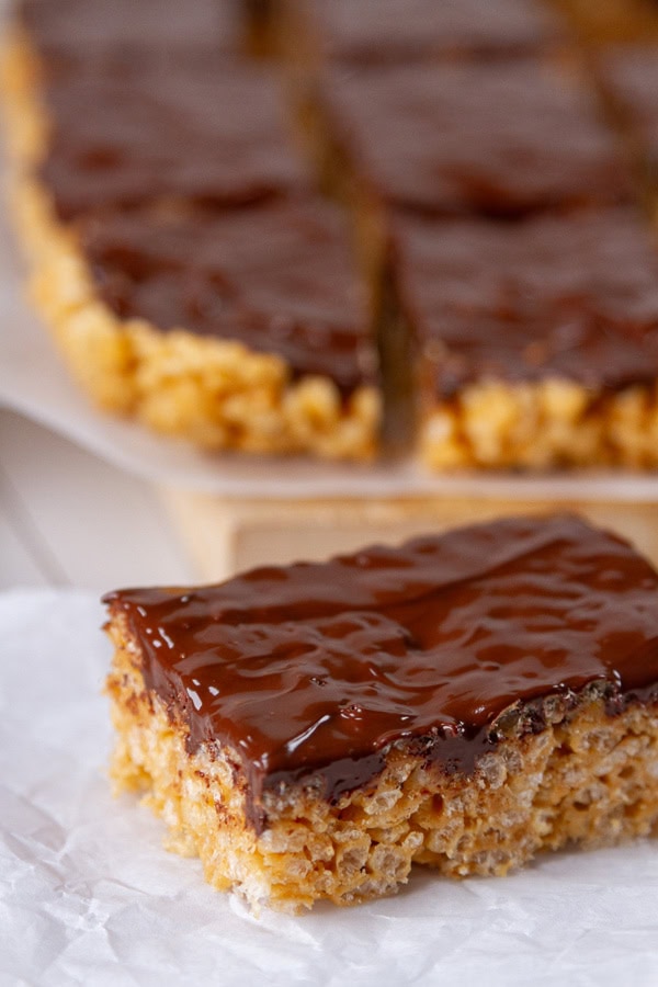 peanut butter rice Krispies squares with a thick layer of chocolate on top.