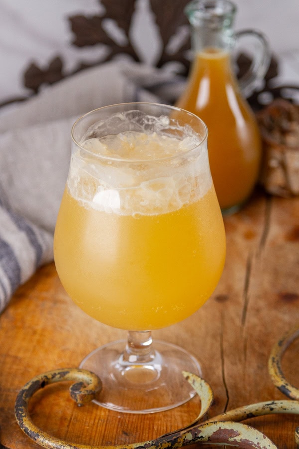 a ginger drink made from ginger chews syrup in front of the bottle of syrup.
