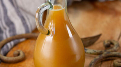 square crop of a glass jar of flavored syrup.