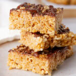 square crop of three rice crispy treats stacked on top of eachother.