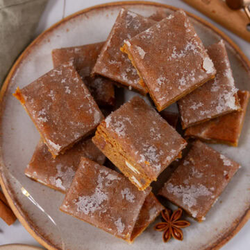 square crop of a plate full of gingerbread bars.