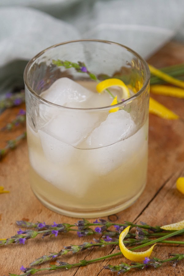 lemon drop mocktail over ice on a wooden background.