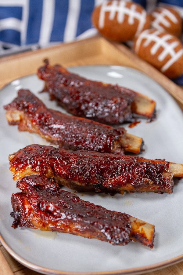 single ribs on a light grey plate with little footballs in the background.