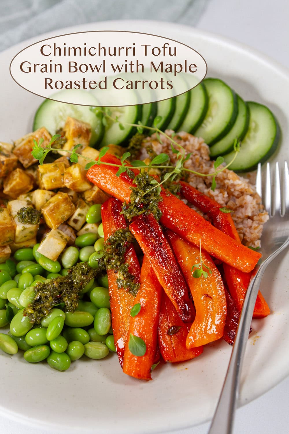 a nourish bowl filled with tofu, carrots, edamame, and cucumbers.