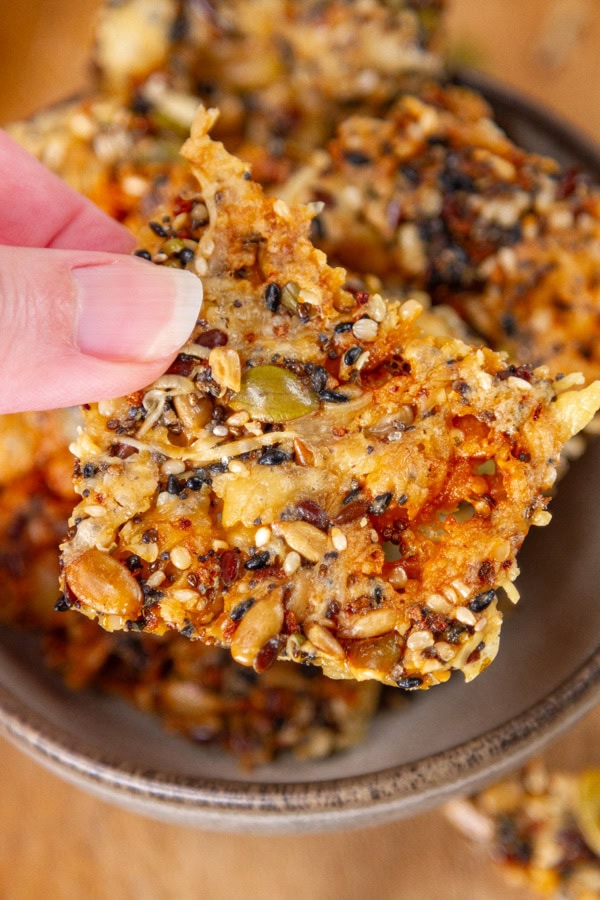 a hand picking up a seed cracker.