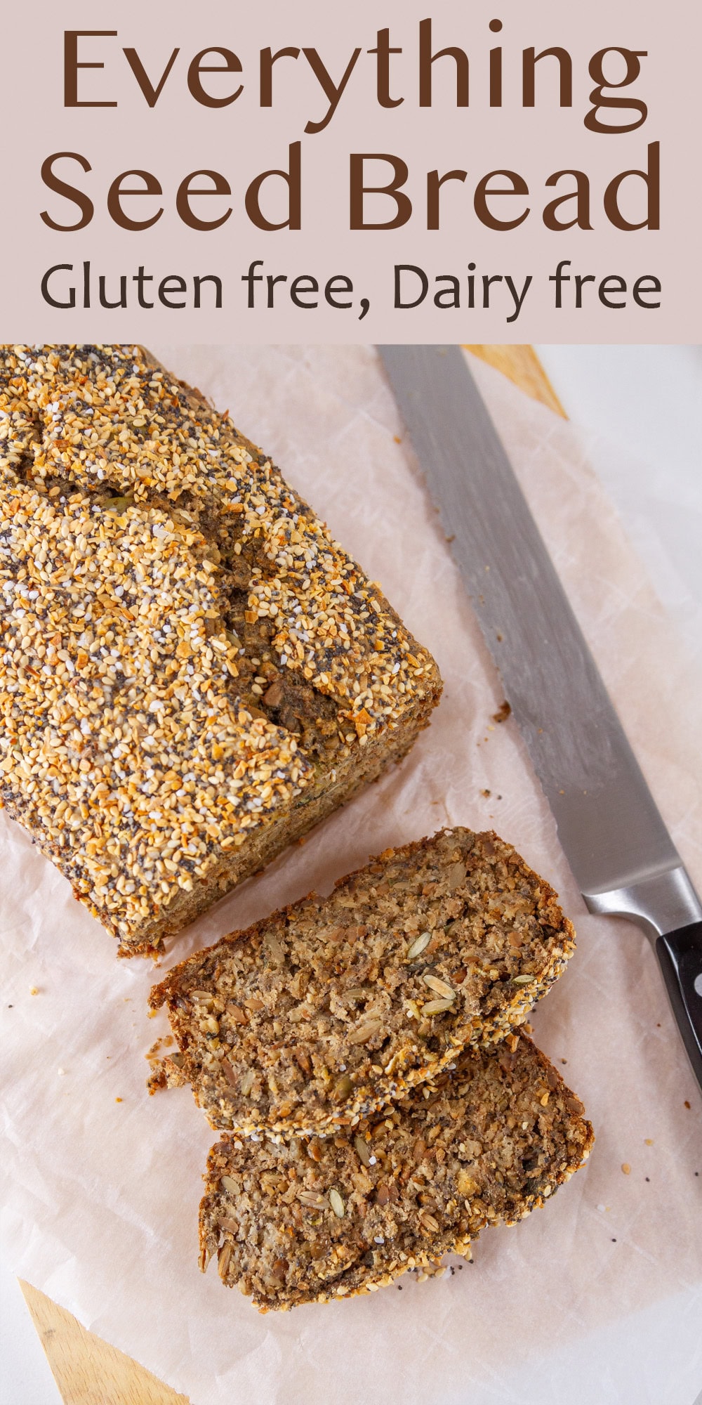looking down on a sliced loaf of seed bread with a knife to the right.