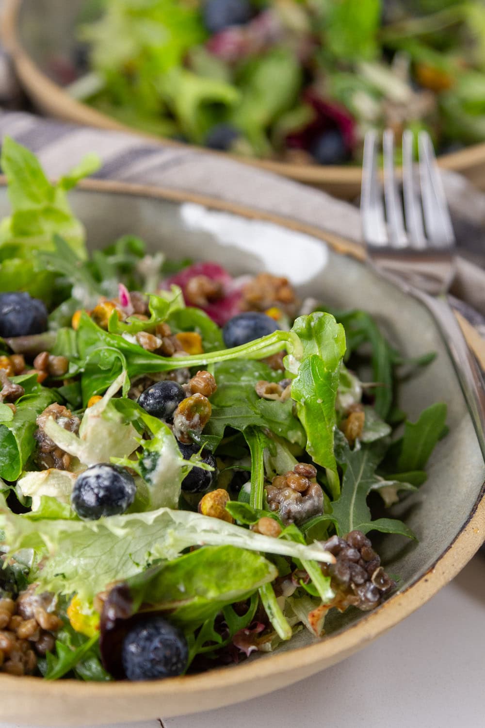 a serving of salad in a bowl with a fork.