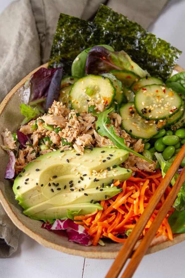 Colorful Asian tuna bowl with seaweed snacks.