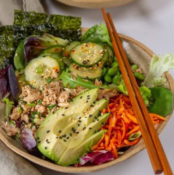 square crop of a healthy Asian tuna bowl with chopsticks on the right.
