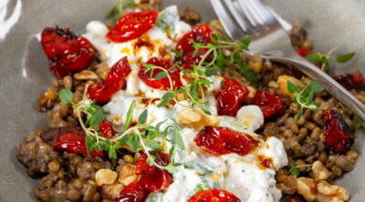 square crop of a bowl with lentils, cottage cheese, and tomatoes in it.