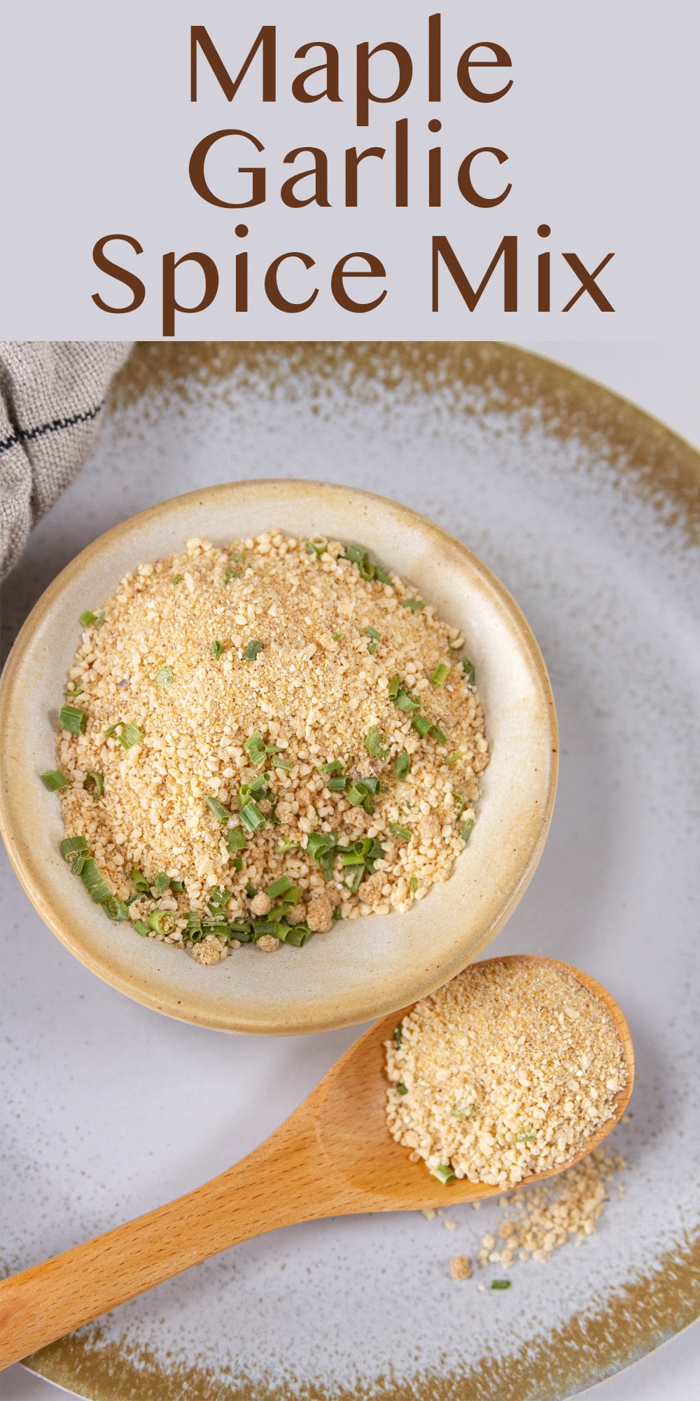 a small dish of spice mix and a wooden spoon holding some of the spice to the lower right.