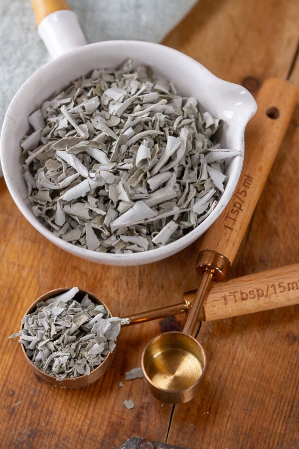 measuring cups and spoons filled with dried white sage.