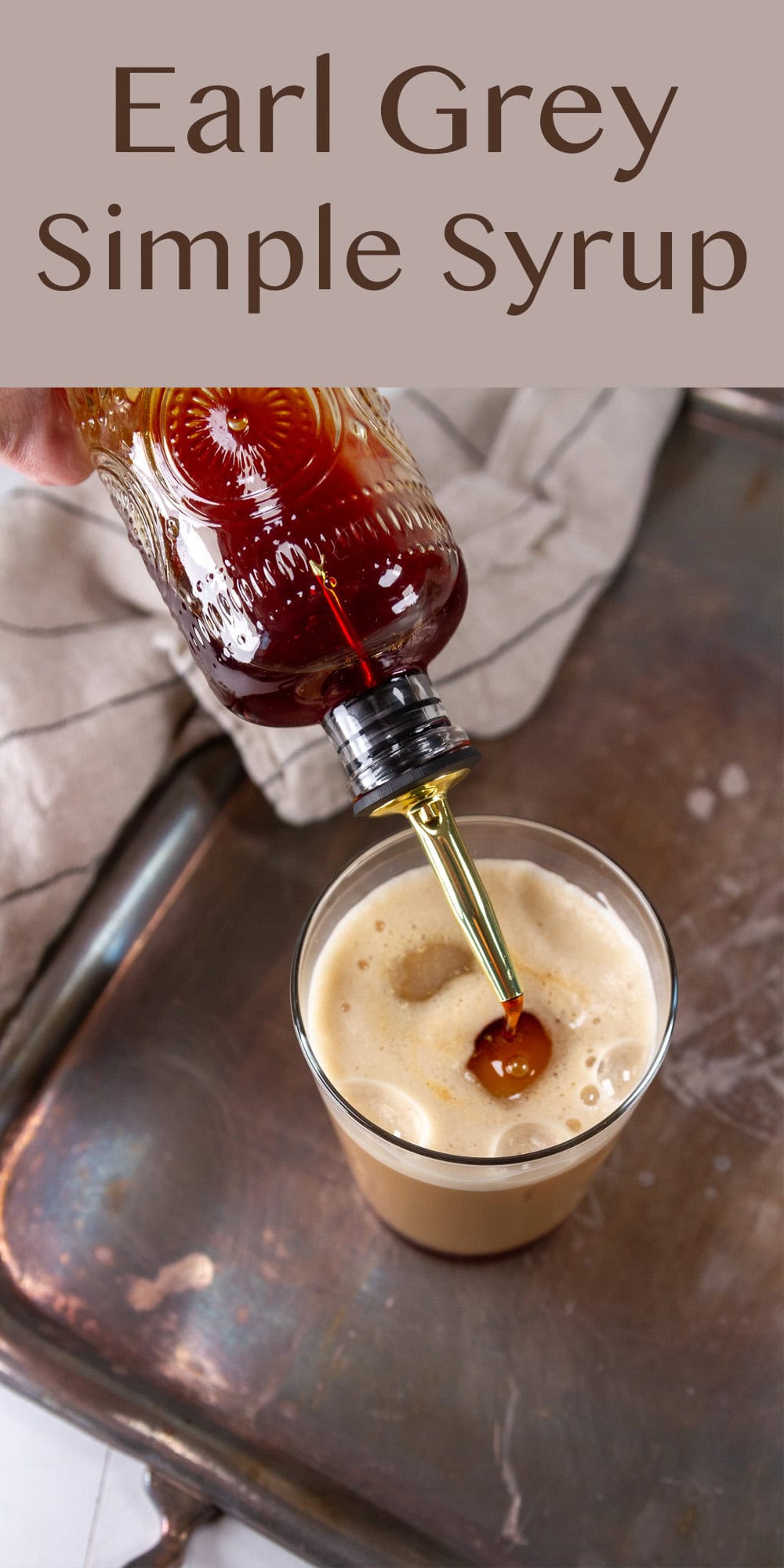 pouring simple syrup into a latte on a metal serving platter.