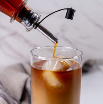 square crop of pouring simple syrup into a glass.