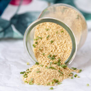 square crop of a spice jar tipped on its side and the spice has spilled out.