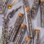 square crop of small glass jars filled with dried lavender sage tea blend.