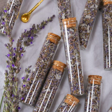 square crop of small glass jars filled with dried lavender sage tea blend.