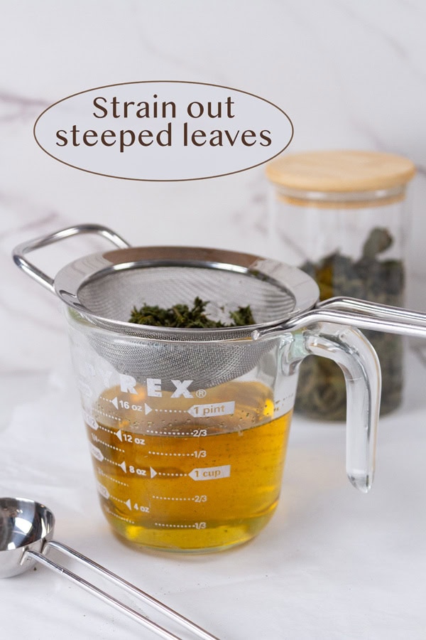 straining steeped leaves from the syrup.