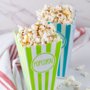 square crop of two brightly colored containers of popcorn.
